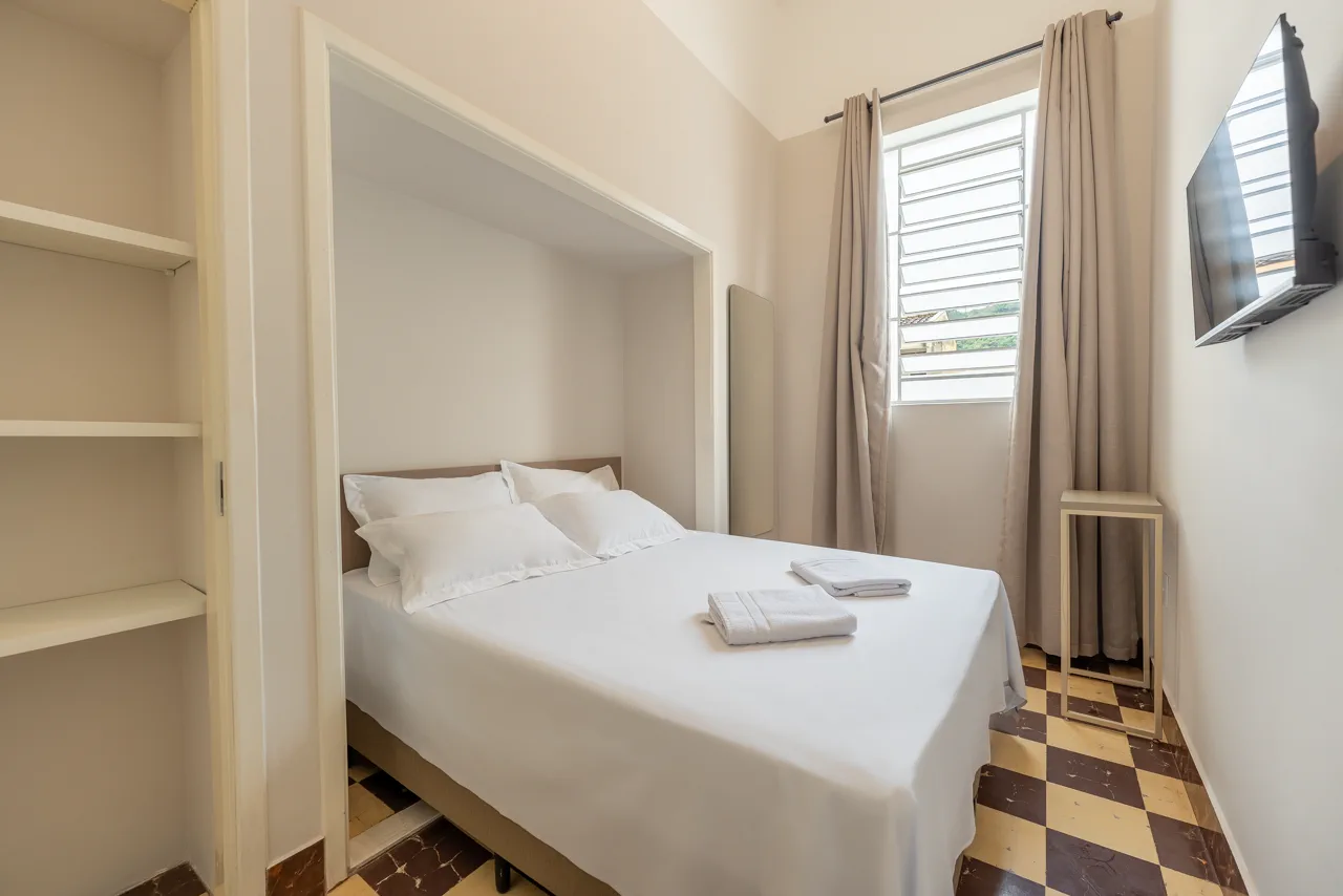 Quarto com estante e televisão